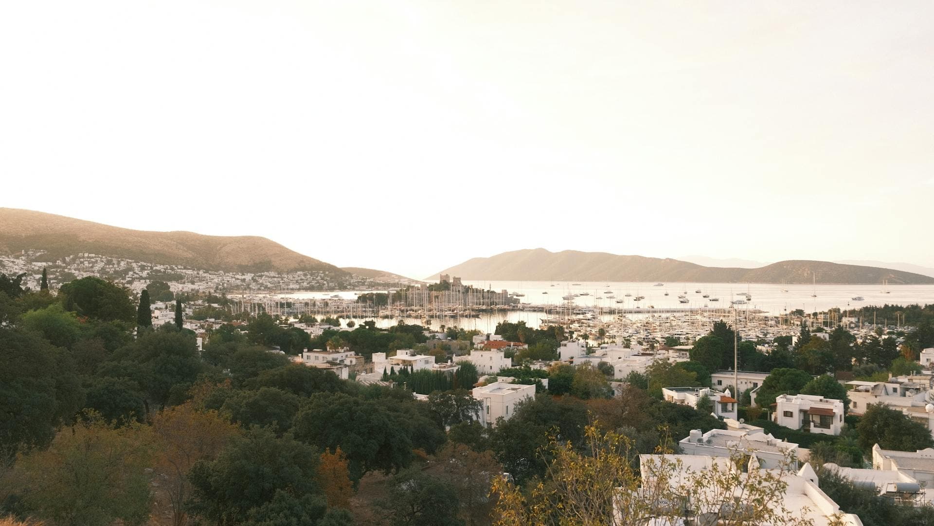 hero · bodrum marina at sunset, castle behind, gulets at anchor
